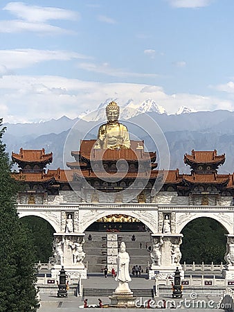 a golden Buddha emerges from the middle of the building and looks like it is floating in the air Editorial Stock Photo