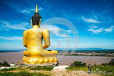 The Golden Buddha at Phu salao temple overlooking the Mekong river and the city of Pakse. Stock Photo