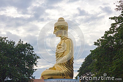 The golden buddha statue on blue sky Stock Photo