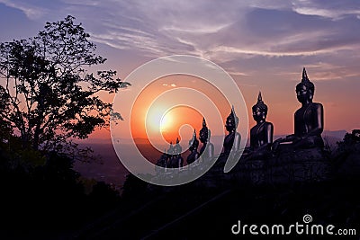 The golden Buddha statue of Phu Salao temple in beautiful sunset moment at Pakse Stock Photo