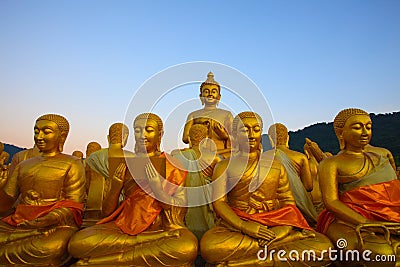 golden buddha statue in temple with beautiful morning light against blue sky use for multipurpose in religion theme Stock Photo