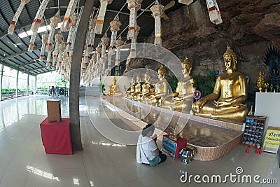 Golden Buddha statues in a cave at Buddhist temple. Editorial Stock Photo