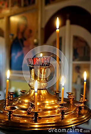 Golden candlestick with burning candles Stock Photo