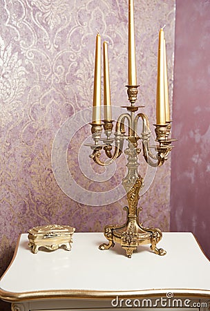 Golden candlestick with five candles on white table Stock Photo