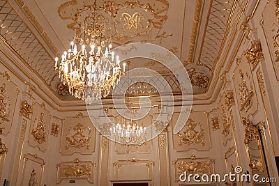 Golden chandeliers and walls with a golden pattern in Nesvizh Castle Editorial Stock Photo