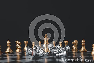 Golden chess king stands among the falling silver chess pieces for the winners and defeats after the match. business strategy Stock Photo