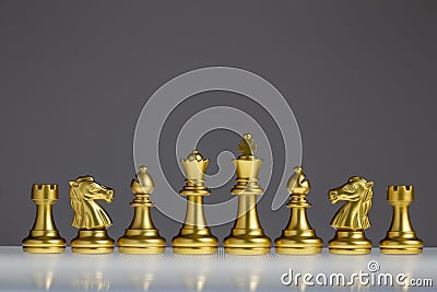 Golden chess set, chess piece icon, King, Queen, Bishop, Horse, Rook, chess game on gray background Stock Photo