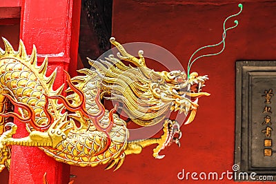 Golden Chinese Dragon on the Red Wall Stock Photo