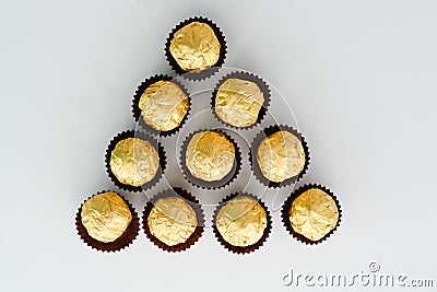 Golden chocolates against a white background Stock Photo