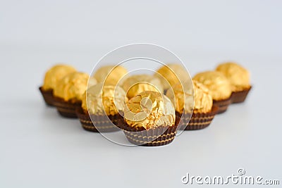 Golden chocolates against a white background Stock Photo