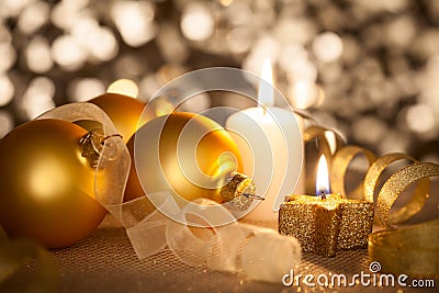 Golden Christmas background with candles, baubles and ribbons Stock Photo