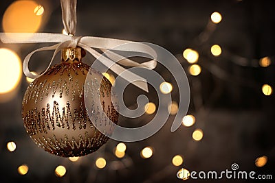 Golden christmas bauble on shiny blackground Stock Photo