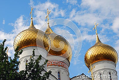 Golden church cupolas. Blue sky with clouds background. Stock Photo