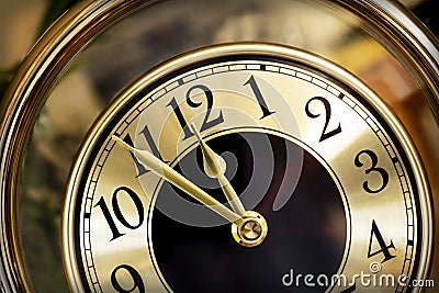 Golden Clock Face Five Minutes to Midnight Stock Photo