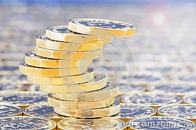 Golden coins with light effects. Precarious stack. Lens flare. Stock Photo