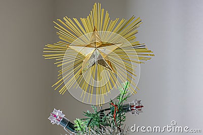 The golden star of Christmas crowns the tree Stock Photo