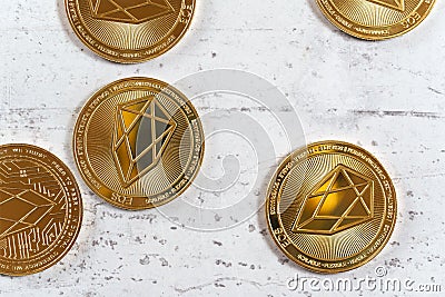 Golden commemorative EOS - EOSIO cryptocurrency - coins on white stone board, view from above Stock Photo