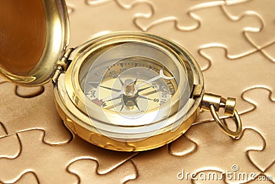 Golden Compass and Puzzle Concept Stock Photo