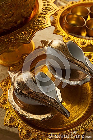 Golden conch shells for the blessing ceremony at a traditional Thai wedding Stock Photo