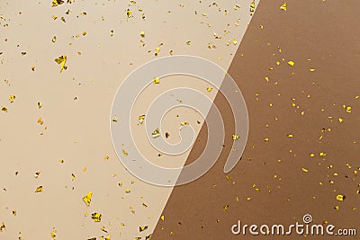 Golden confetti on earthy brown beige paper geometric trendy background. Festive holiday backdrop. Birthday congratulations Stock Photo