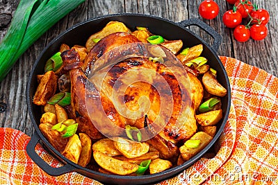 Golden crispy skin chicken grilled in oven with potato wedges Stock Photo