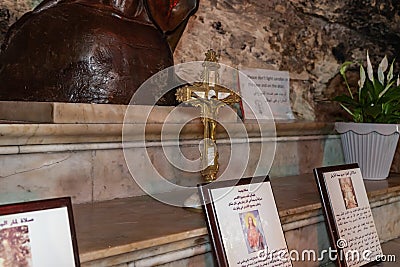 The golden crucifix stands in the main hall of the Stella Maris Monastery which is located on Mount Carmel in Haifa city in Editorial Stock Photo