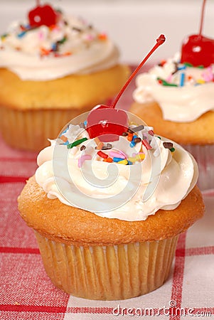 Golden cupcakes with buttercream and sprinkles Stock Photo