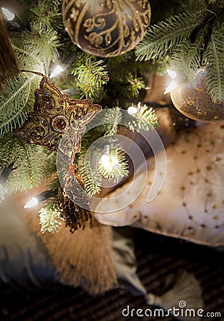 Golden decorations hanging on Christmas tree Stock Photo