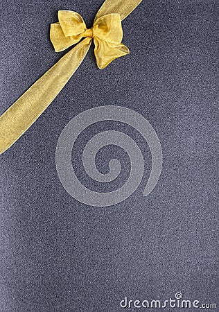 Golden decorative bow on the black background .Vertical shot, empty space for text Stock Photo