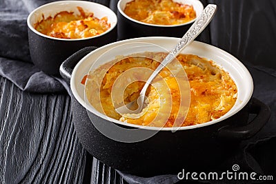 Golden delicious gratin made of potatoes, sour cream, onions and cheddar cheese close-up in a pan. horizontal Stock Photo