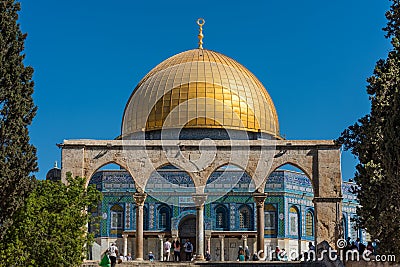 The Golden Dome of the Rock, or Qubbat al-Sakhra, and stone gate ruins in an Islamic shrine located on the Temple Mount in the Old Editorial Stock Photo