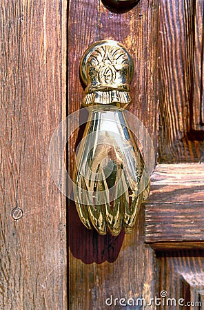 Golden doorknocker with hand shape Stock Photo