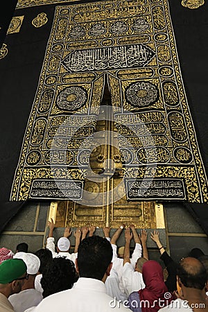 MECCA, SAUDI ARABIA - MAY 01 2018: The golden doors of the Holy Kaaba closeup, covered with Kiswah. Massive lock on the doors. Ent Editorial Stock Photo