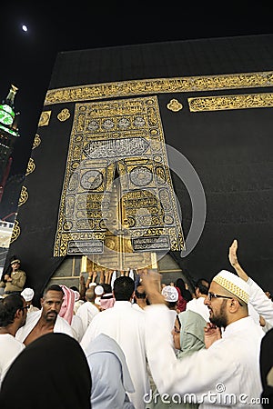 MECCA, SAUDI ARABIA - MAY 01 2018: The golden doors of the Holy Kaaba closeup, covered with Kiswah. Massive lock on the doors. Ent Editorial Stock Photo