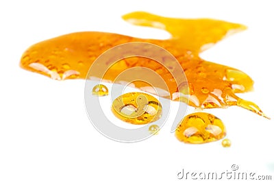 Golden drops cannabis wax close up macro on white background Stock Photo