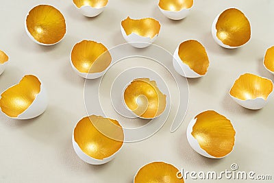 Golden eggshell on an ecru background. The concept of the modern vision of Easter. Happy Easter advertising banner. Abstract still Stock Photo