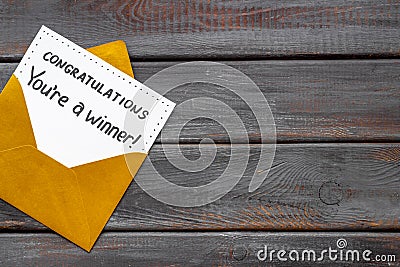 Golden envelope with award card Congratulations You are a winner. Overhead view Stock Photo