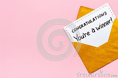 Golden envelope with award card Congratulations You are a winner. Overhead view Stock Photo