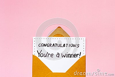 Golden envelope with award card Congratulations You are a winner. Overhead view Stock Photo