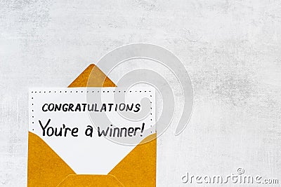 Golden envelope with award card Congratulations You are a winner. Overhead view Stock Photo