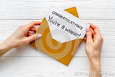 Golden envelope with award card Congratulations You are a winner. Overhead view Stock Photo