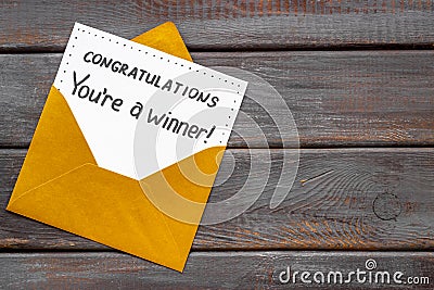 Golden envelope with award card Congratulations You are a winner. Overhead view Stock Photo