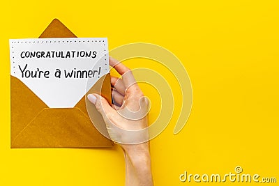 Golden envelope with award card Congratulations You are a winner. Overhead view Stock Photo