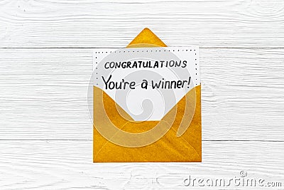 Golden envelope with award card Congratulations You are a winner. Overhead view Stock Photo