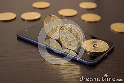 Golden Etherium coin close up on smartphone - business concept of crypto currency. Editorial Stock Photo