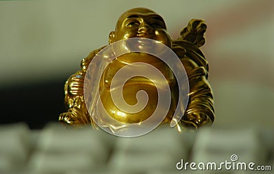 Golden figurine behind the keyboard Stock Photo