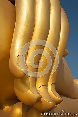 Golden finger of big buddha statue Stock Photo