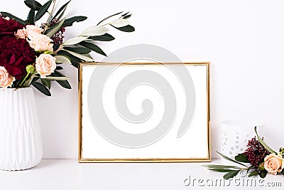 Golden frame mock-up on white wall Stock Photo