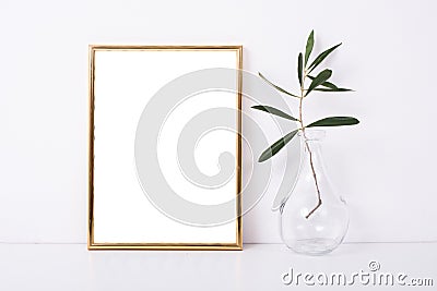 Golden frame mock-up on white wall Stock Photo