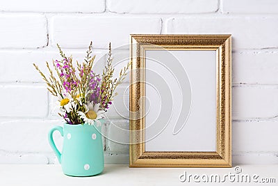 Golden frame mockup with chamomile and purple flowers in mint g Stock Photo